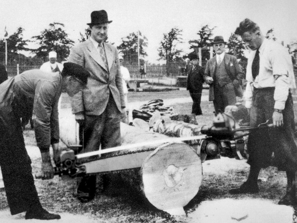 Two men with a chainsaw