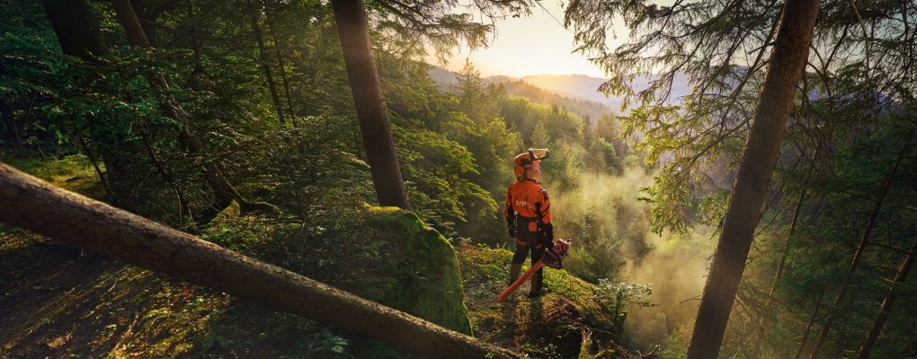 Woman with chainsaw in forest