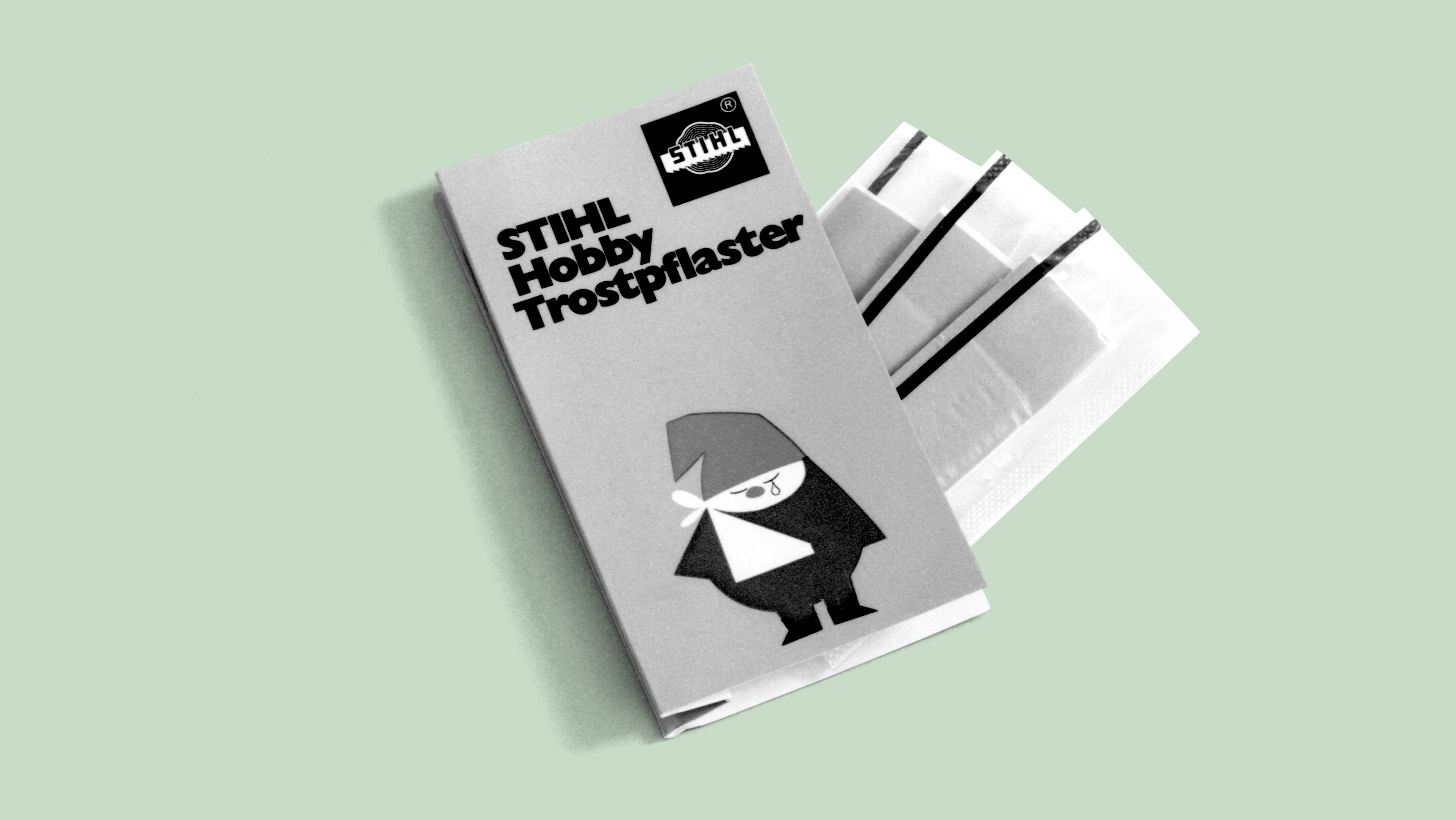 Pack of adhesive bandages with the STIHL hobby gnome illustration; black and white photo.
