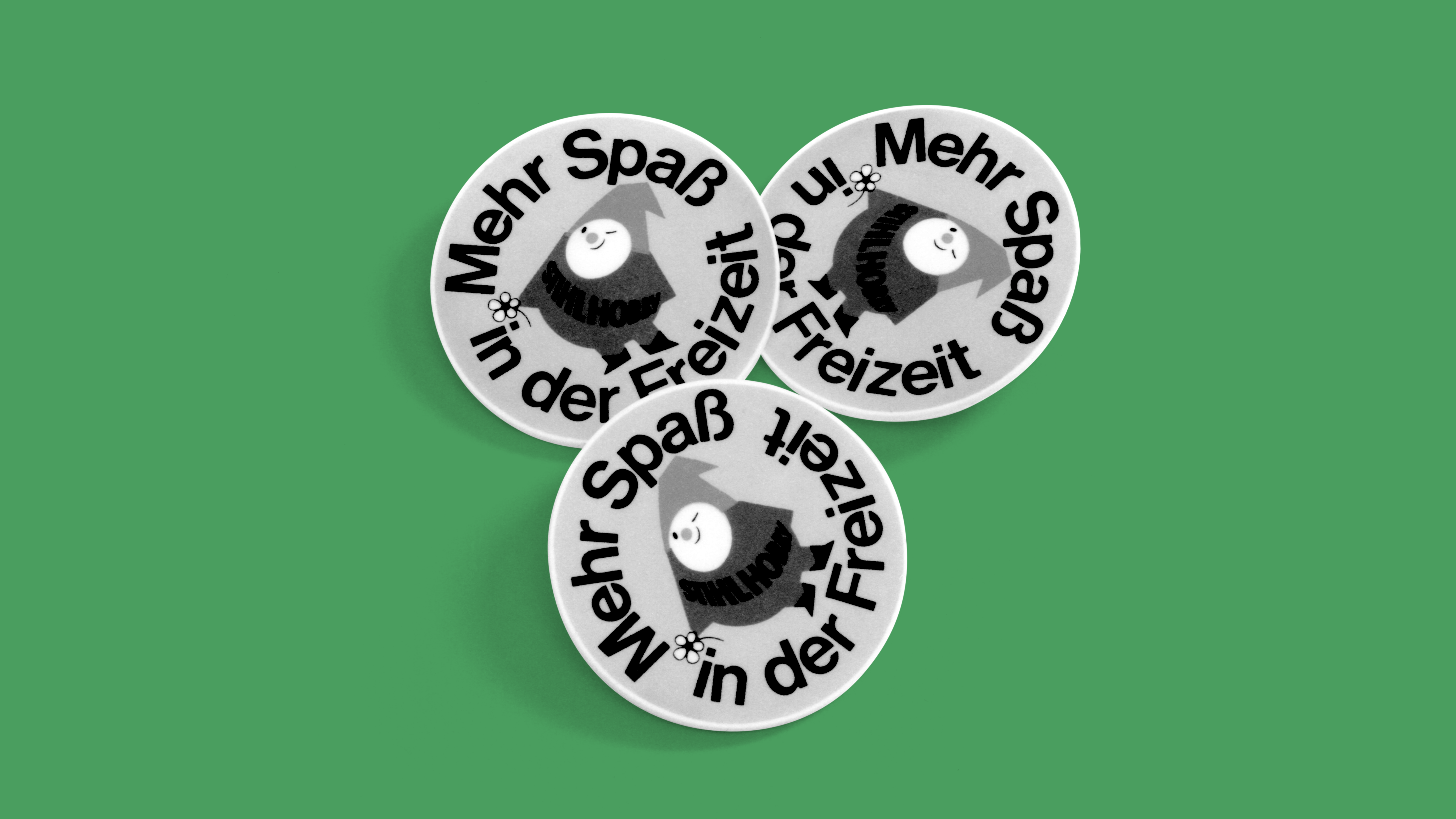 Pin with the STIHL hobby gnome illustration; black and white photo.