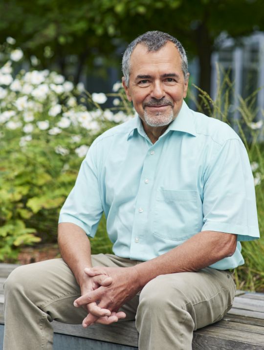 Portrait of a seated man with a beard.