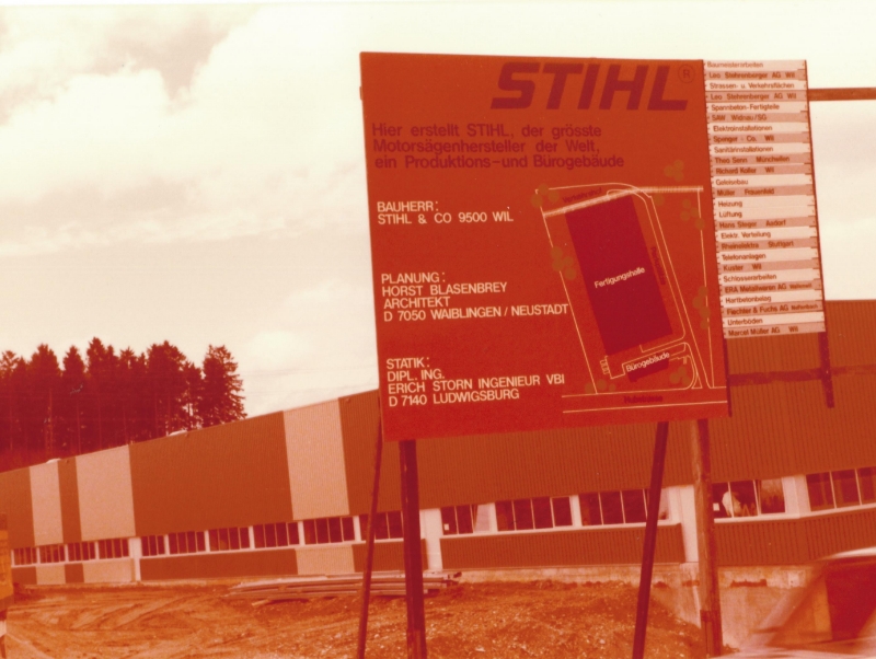 Sepia image of a construction sign in front of the STIHL production site in Wil.