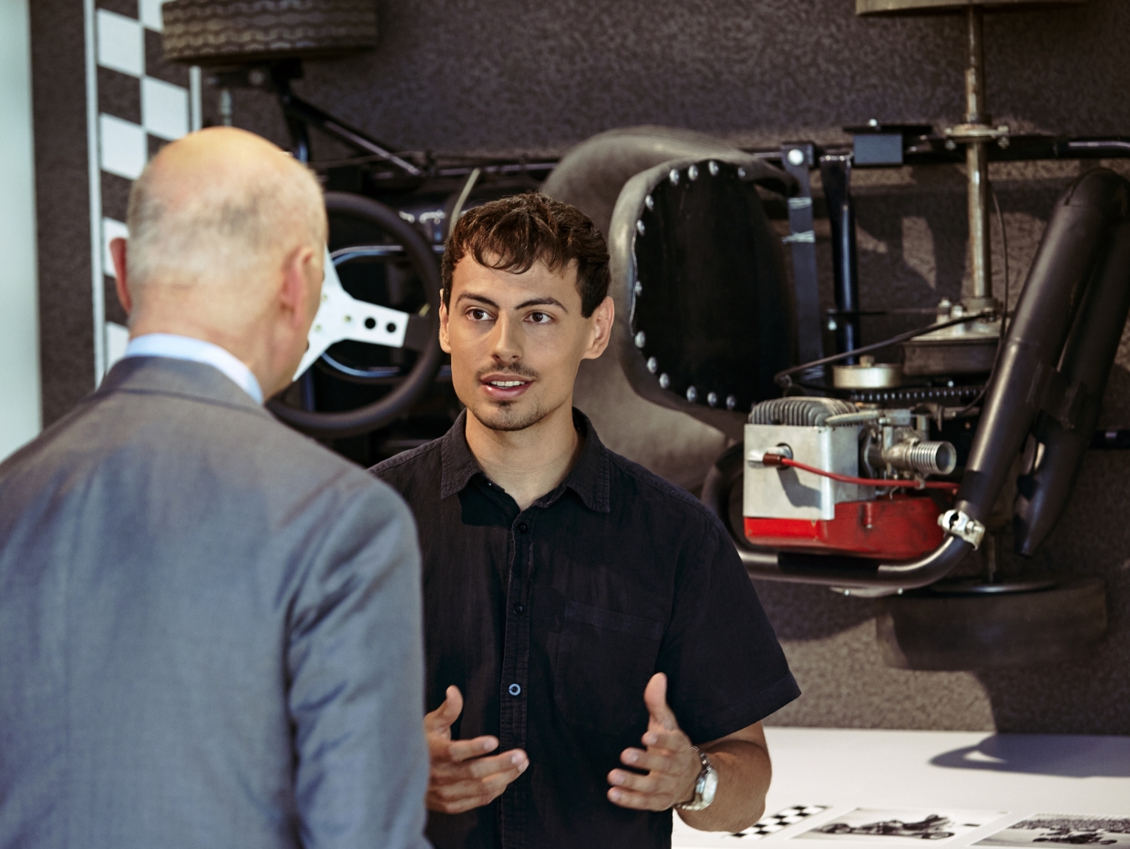 Dr. Nikolas Stihl and Tamino Soubawi in conversation; a go-kart hanging on the wall behind them.