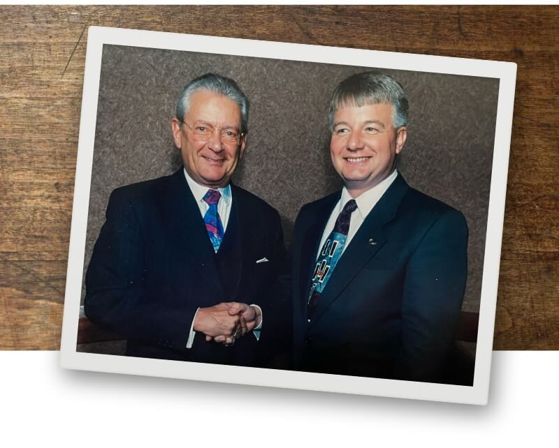 Wayne Sutton and Hans Peter Stihl shaking hands.