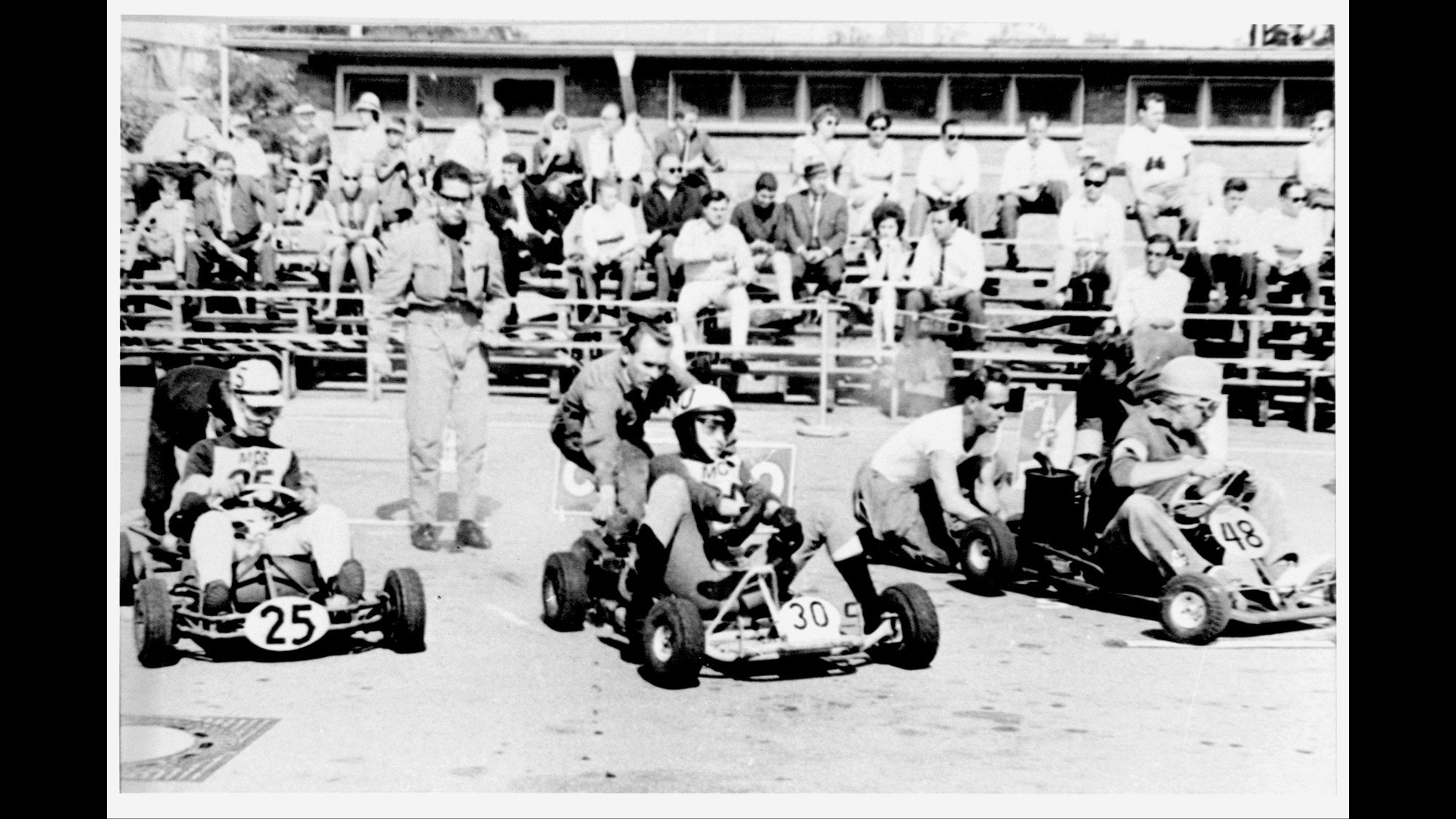 Start of a go-kart race; black-and-white photo.