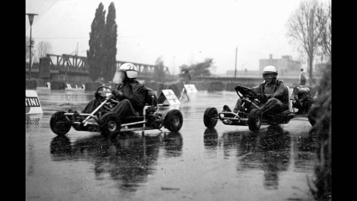 Go-karts during a race; black-and-white photo.