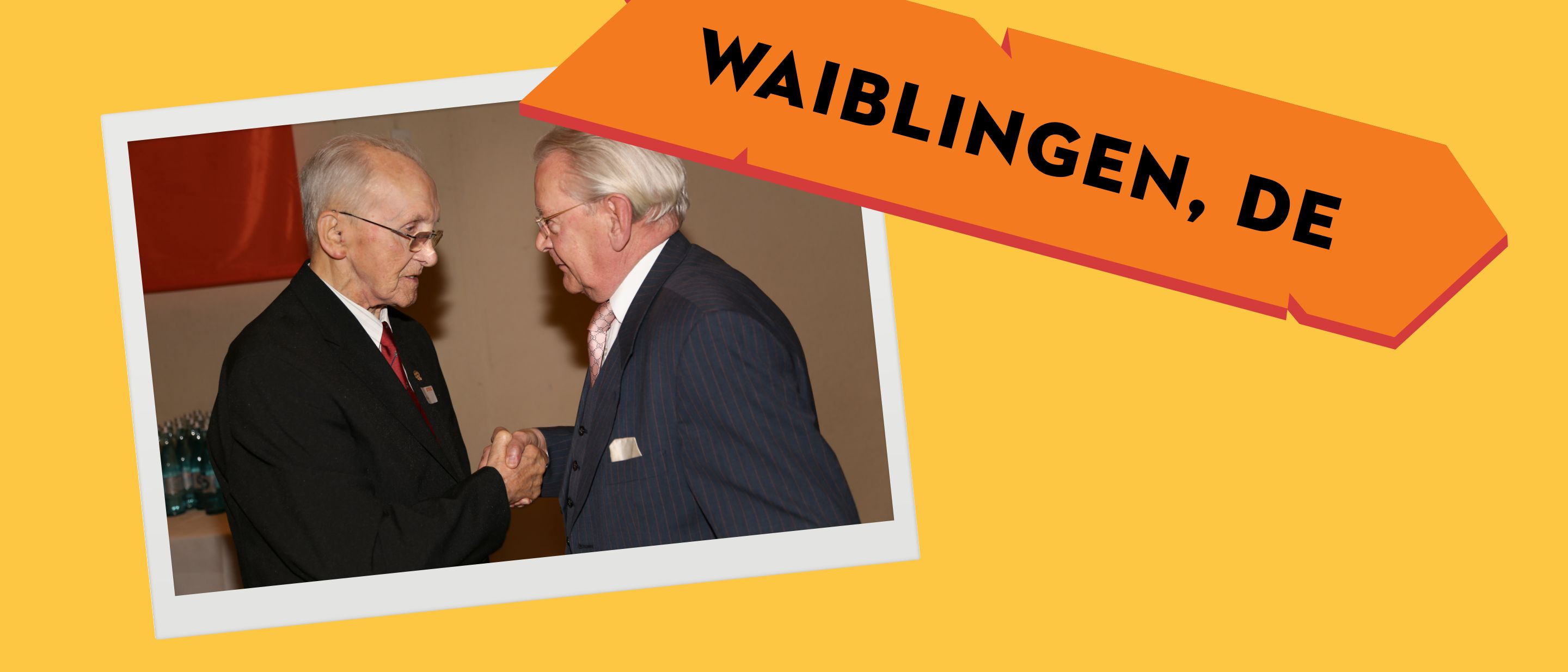 Julius W&ouml;rz shakes hands with Hans Peter Stihl at a celebration in Waiblingen.